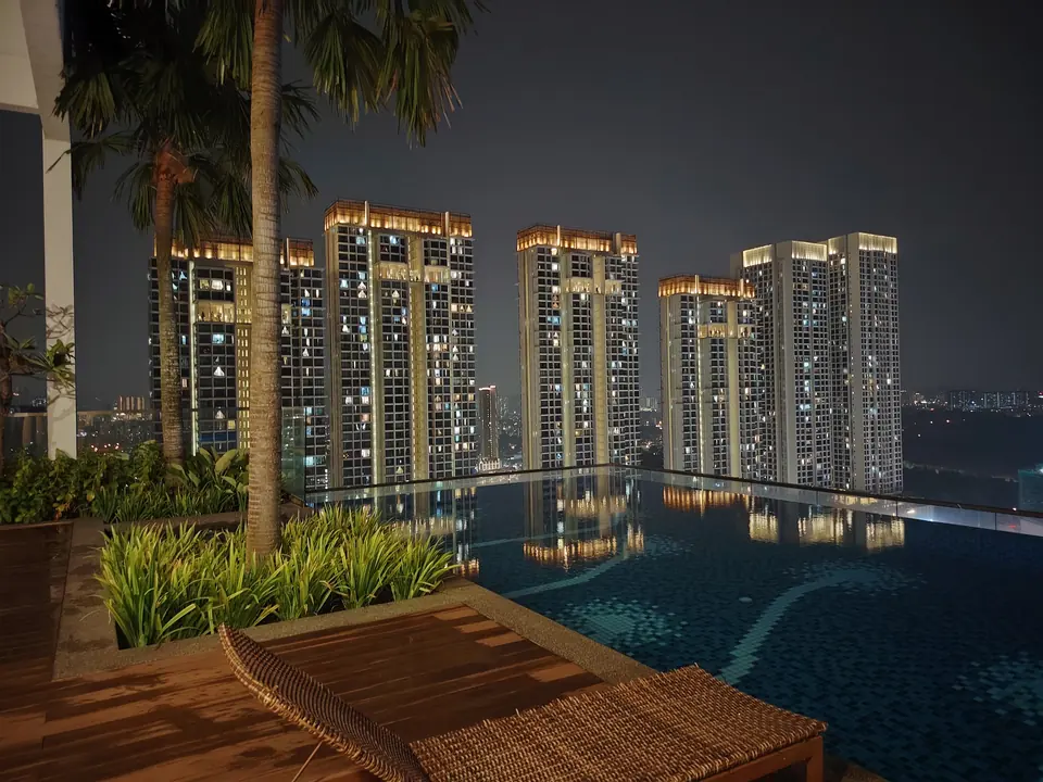 Infinity pool at Revo Pavilion at night, with the Bukit Jalil skyline